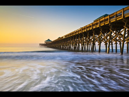 Shot of ocean and pier at Folly Beach in Charleston, South Carolina. 