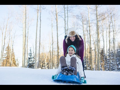 Mother and daughter playing in the snow in Park City, Utah.