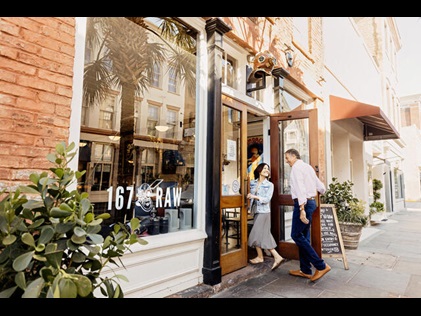 Couple walking into restaurant in Charleston, South Carolina. 