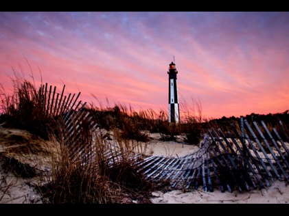 Pink and purple sunset skies above Cape Henry Lighthouse, Virginia Beach, Virgina. 