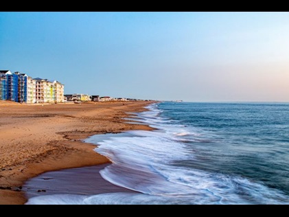 Blue Atlantic ocean waters washing ashore golden sands, Sandbridge Beach, Virginia.