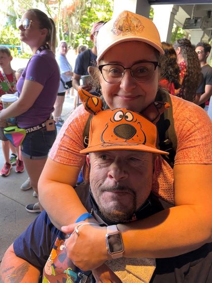 A Hilton Grand Vacations Owner and her husband pose at Universal Studios Florida while on vacation