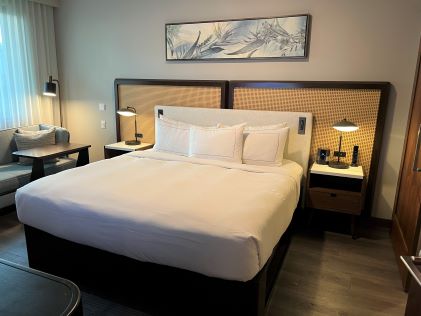 A bed and nightstands in the primary bedroom in the 2-Bedroom Suite at Maui Bay Villas, a Hilton Grand Vacations