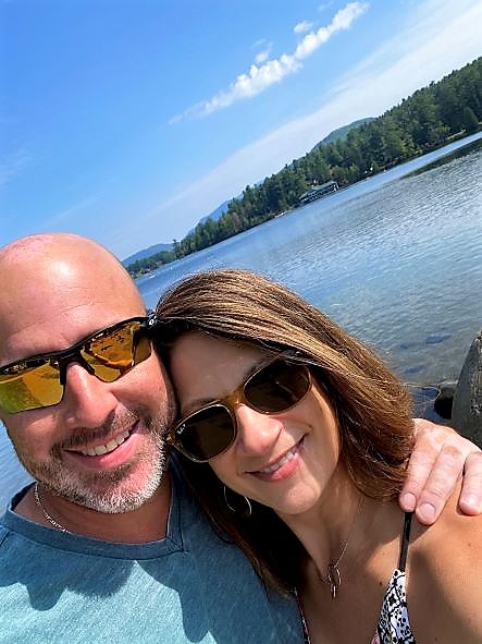 Hilton Grand Vacations Owners posing in front of Lake Placid, New York.