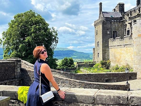 Hilton Grand Vacations Owner posing atop castle, Scotland. 