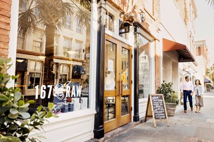 Couple strolling Charleston street to upscale restaurant, low country cuisine, South Carolina. 