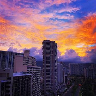 Hawaiian skyscrapers silhouetted against a colorful sunset.
